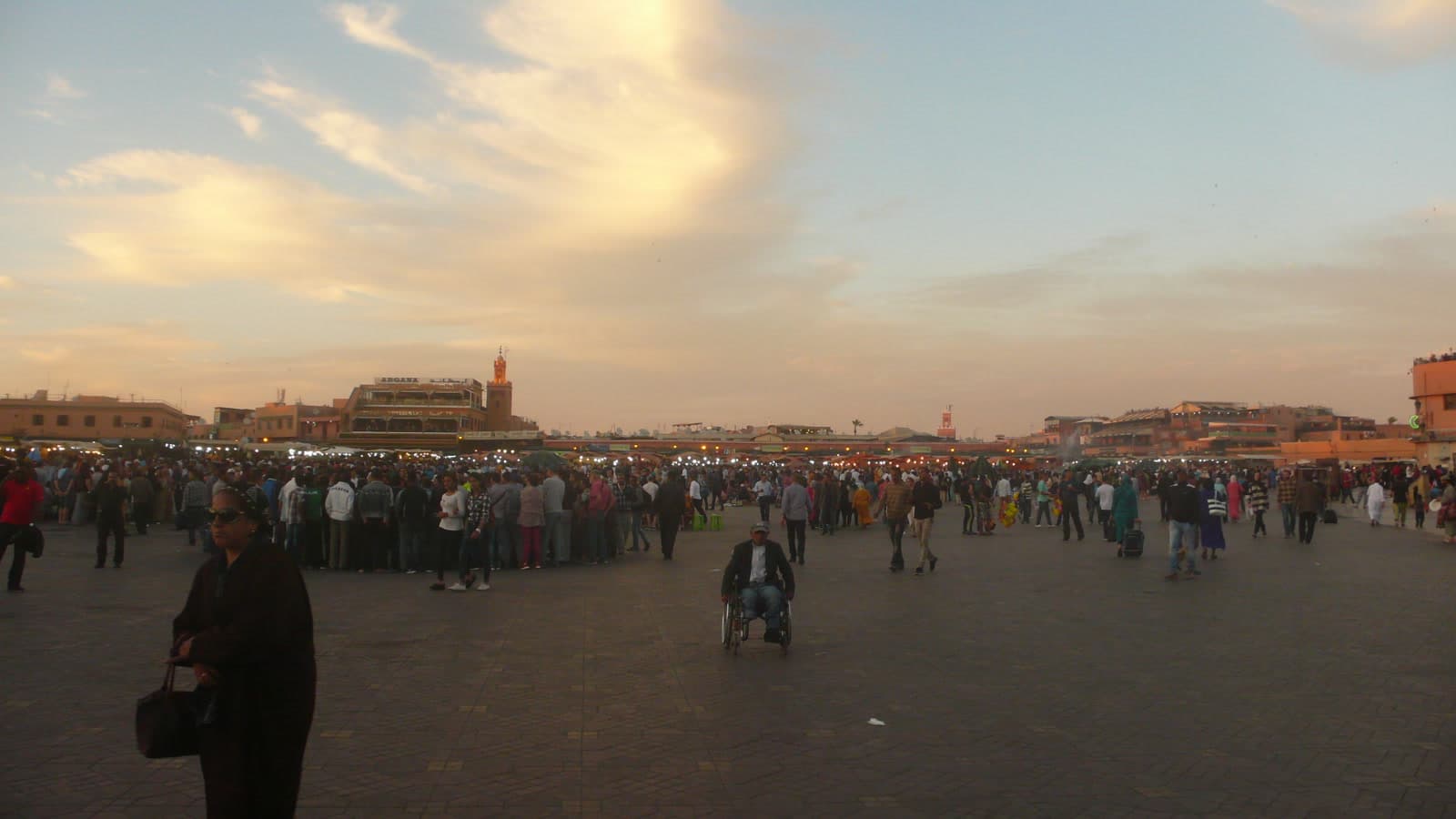 Crowds in Jemaa el-Fna square in Marrakech at sunset