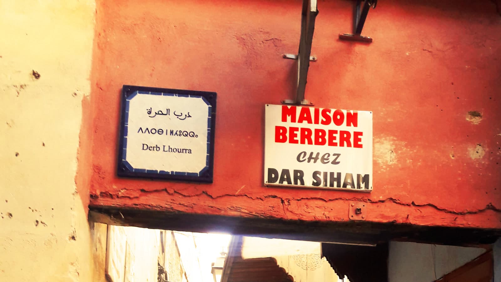Arabic, Tifinagh and French signs above an alley in the Fes medina