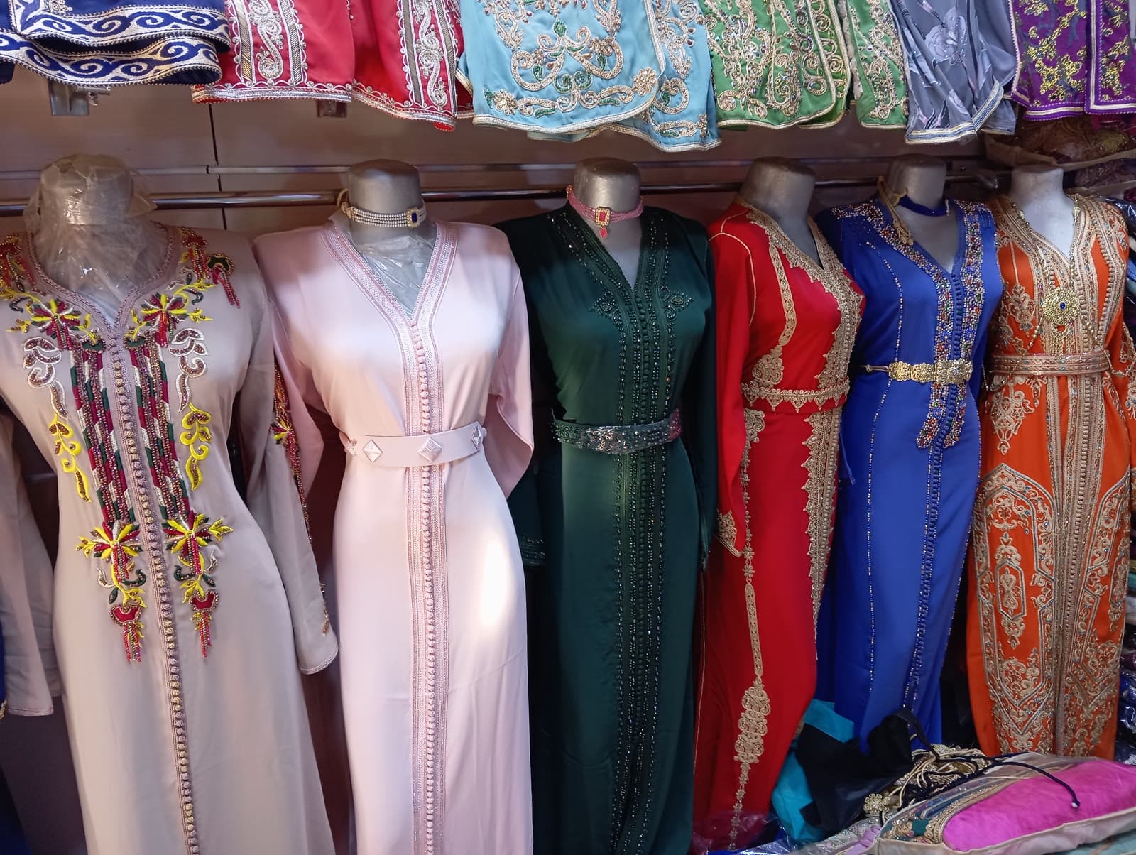 Decorated Moroccan women's garments displayed on mannequins in a clothing shop