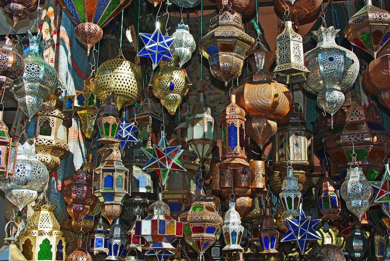 Is Morocco expensive β a busy Marrakech souk market where most travel spending happens