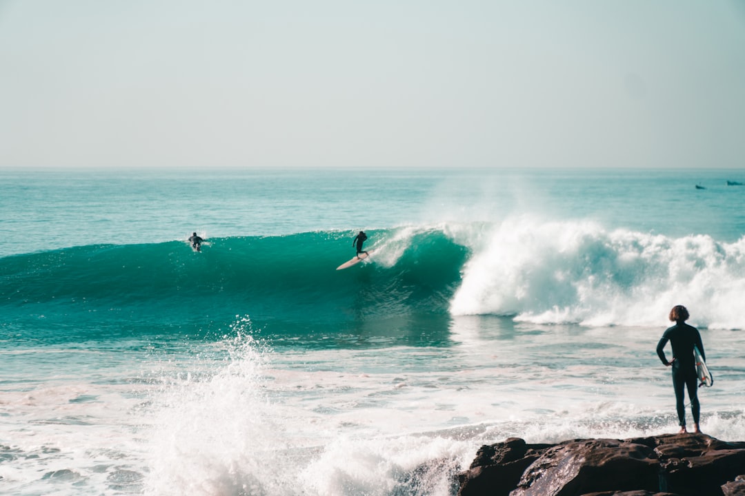Surfing in Morocco — a surfer riding a right-hand point break at Anchor Point near Taghazout in morning light