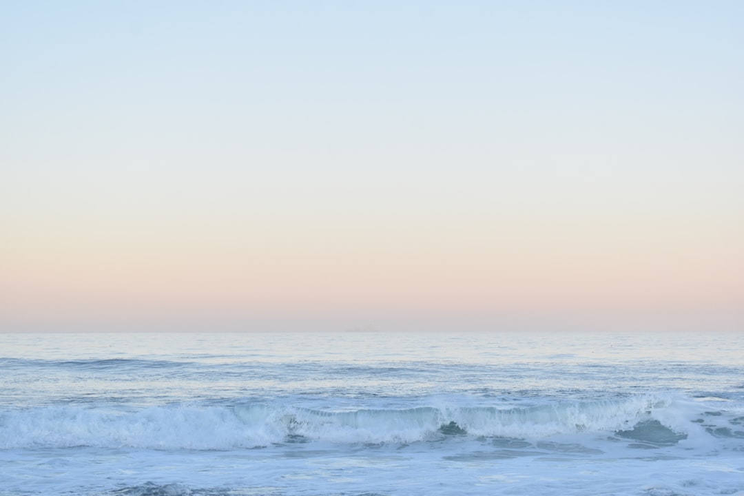 Best time to surf Morocco - clean winter point-break wave peeling at dawn on the Atlantic coast with offshore spray and an empty lineup