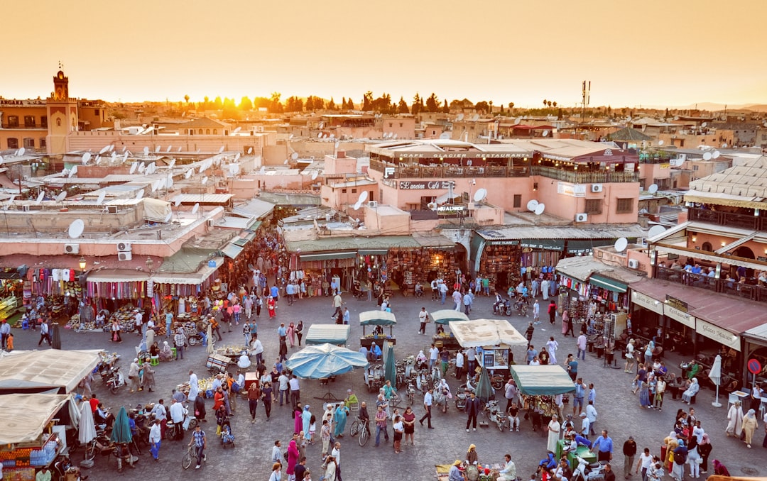 Morocco trip cost β souk food stall in Marrakech with dirham price signs on olives, dates and grilled skewers