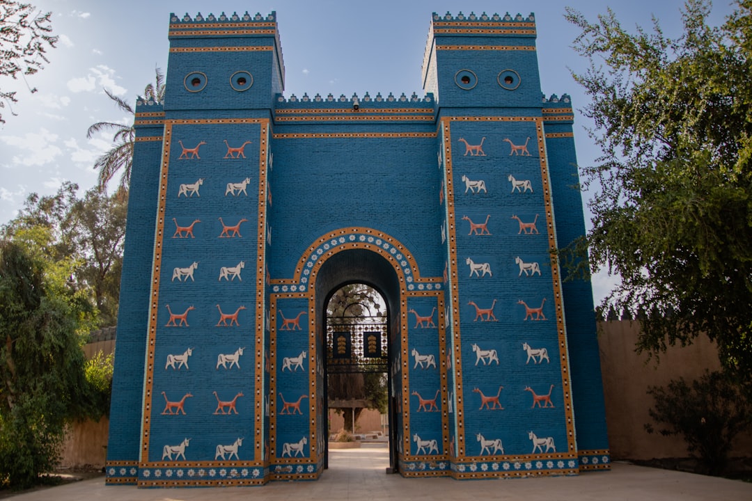 Bab Bou Jeloud, the Blue Gate of Fes — cobalt-blue tiled triple-arch gate framing two medina minarets