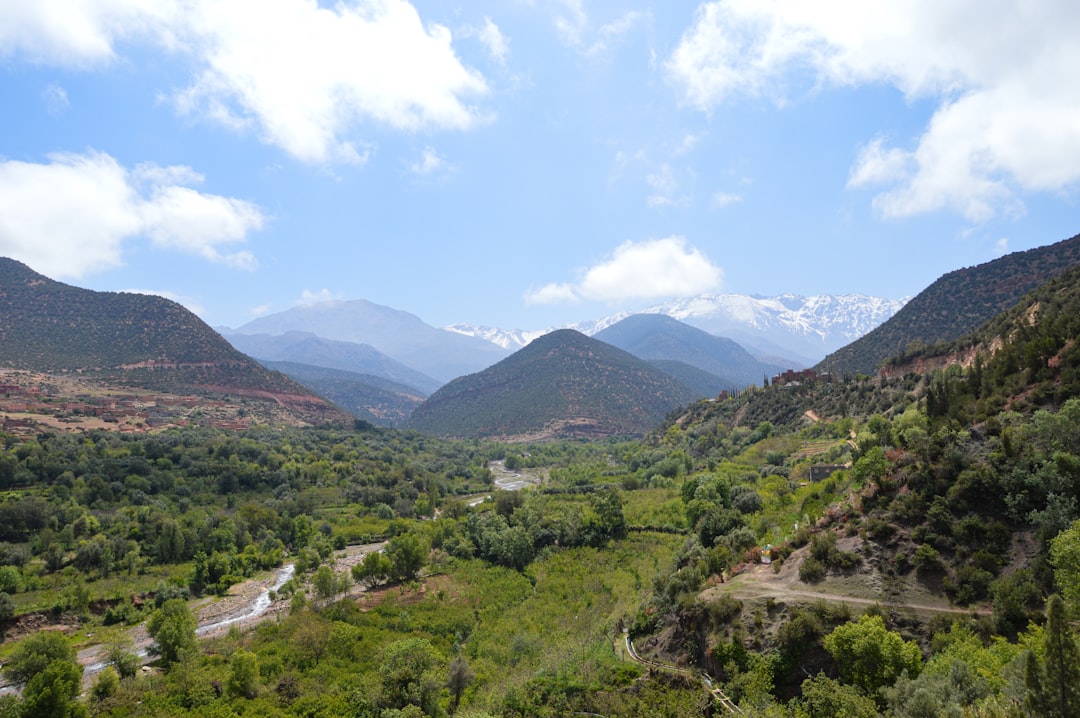Toubkal summit views — panorama of snow-streaked High Atlas peaks and ridgelines under dramatic mountain light